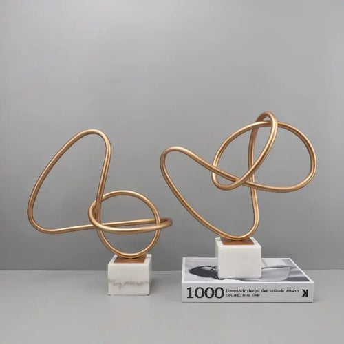 Abstract gold line geometric metal sculptures on marble living room decor