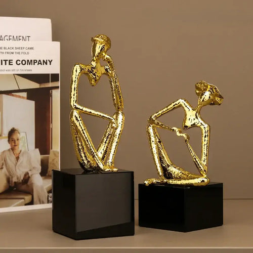 Abstract golden hat thinker figure living room gold & black decor
