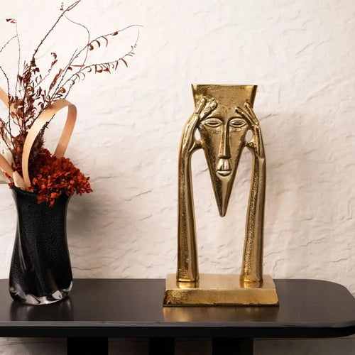 Abstract golden masked figure sculpture living room decor