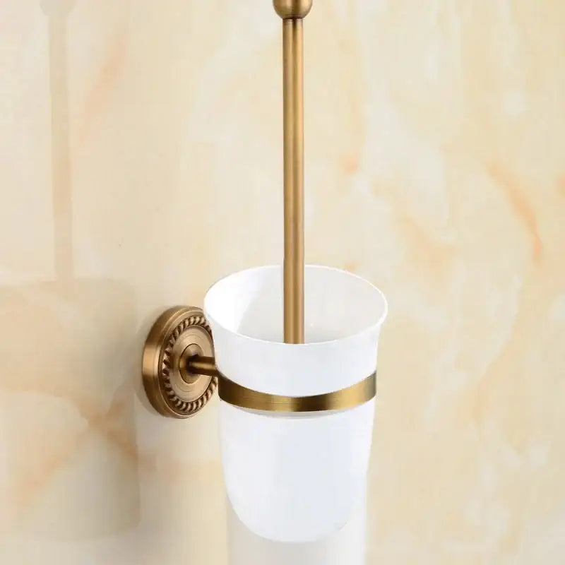 Antique brass bathroom set with ornate mounts and ceramic brush cup
