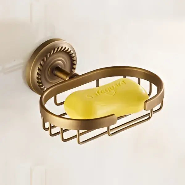 Antique brass bathroom set with ornate mounts and ceramic brush cup