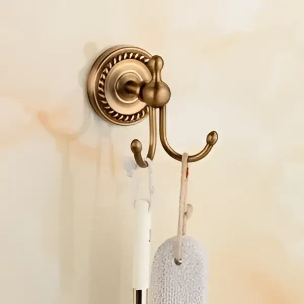 Antique brass bathroom set with ornate mounts and ceramic brush cup