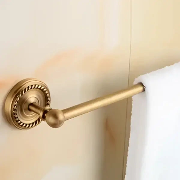 Antique brass bathroom set with ornate mounts and ceramic brush cup
