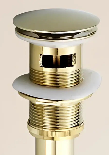 Antique brass sink drain with white rubber seal – bathroom waste
