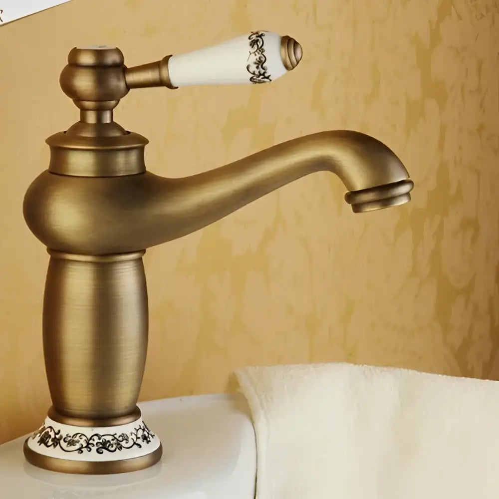 Antique bronze bathroom faucet with white ceramic ornate handle