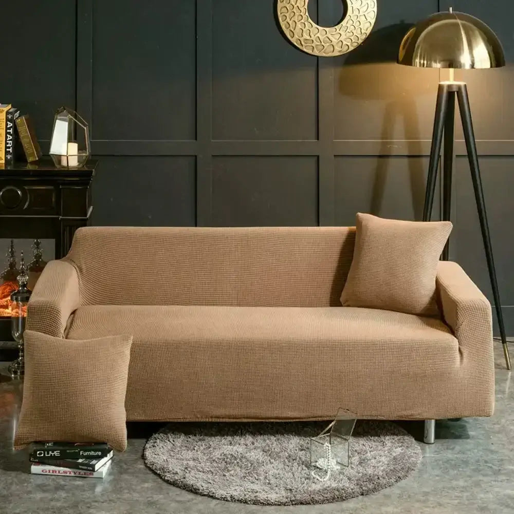Beige textured quilted sofa cover with pillows for living room