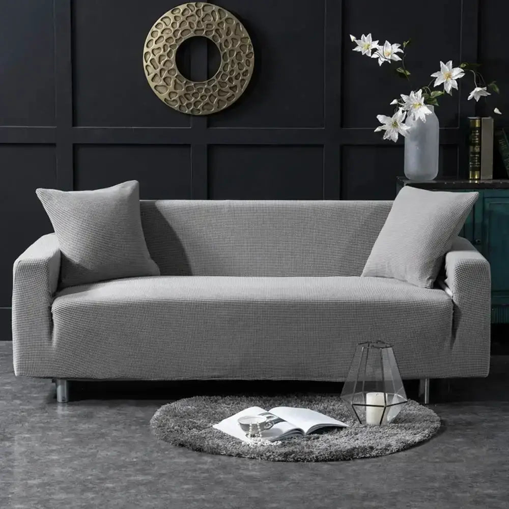 Beige textured quilted sofa cover with pillows for living room
