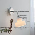 Chrome adjustable arm wall lamp with ribbed glass shade – bedroom