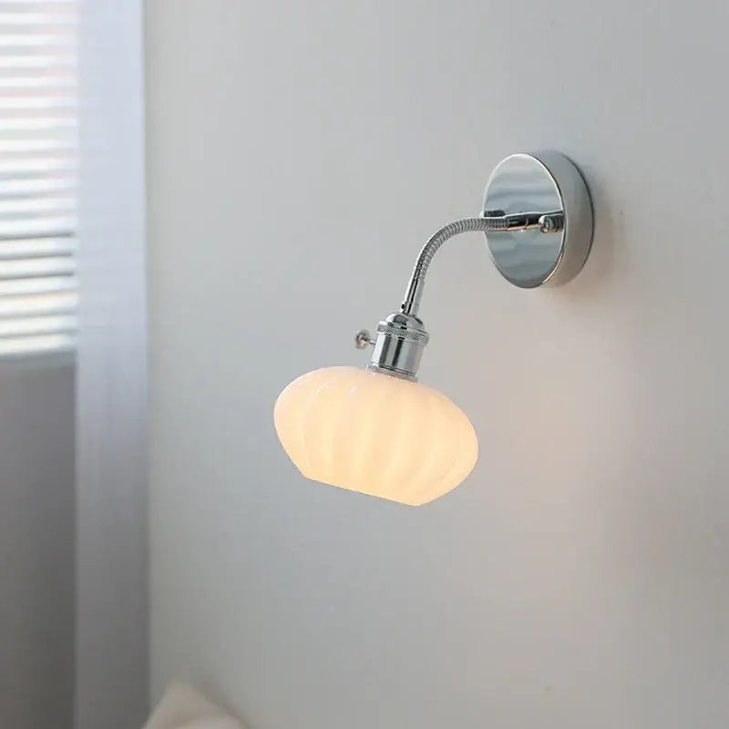 Chrome adjustable arm wall lamp with ribbed glass shade – bedroom