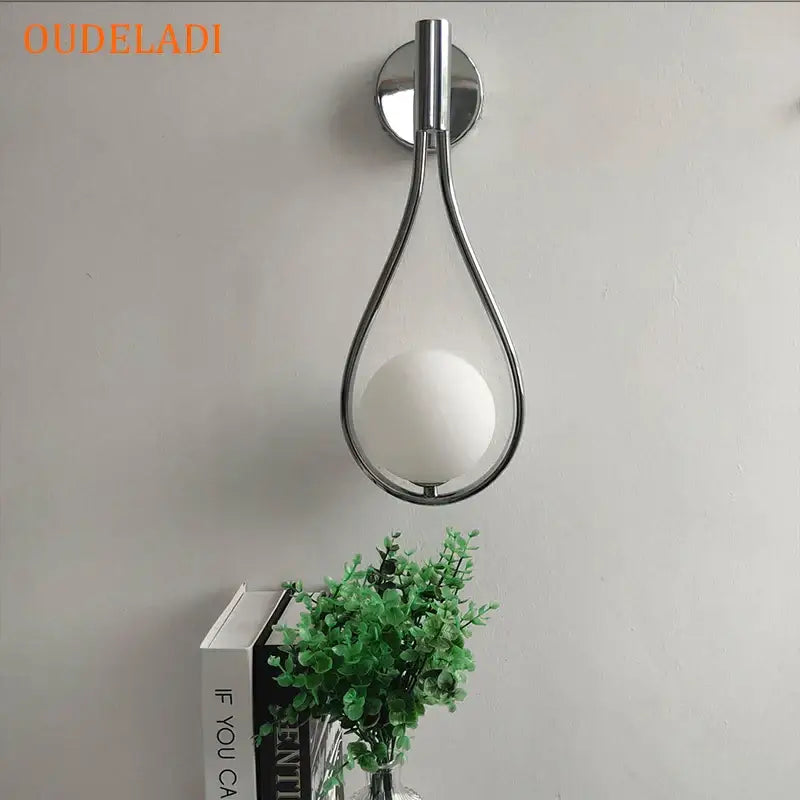 Chrome teardrop wall sconce with white glass ball for bedroom