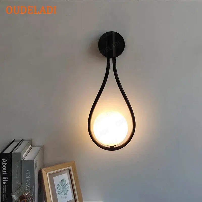 Chrome teardrop wall sconce with white glass ball for bedroom