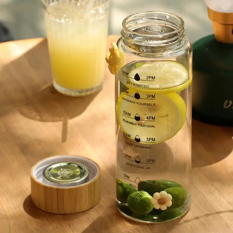 Minimalist glass water bottle with bamboo lid and kitchen time scale