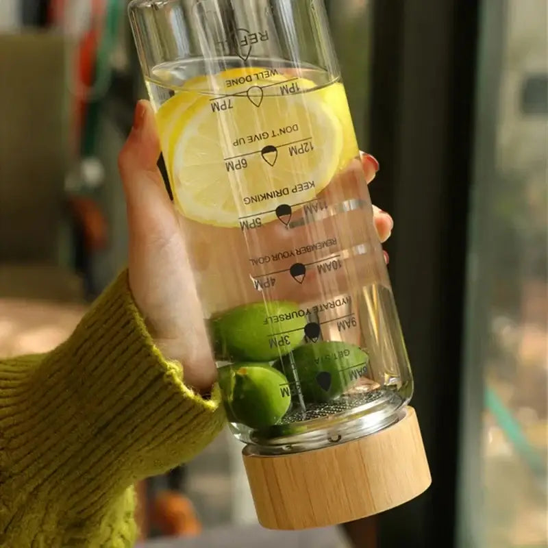Minimalist glass water bottle with bamboo lid and kitchen time scale
