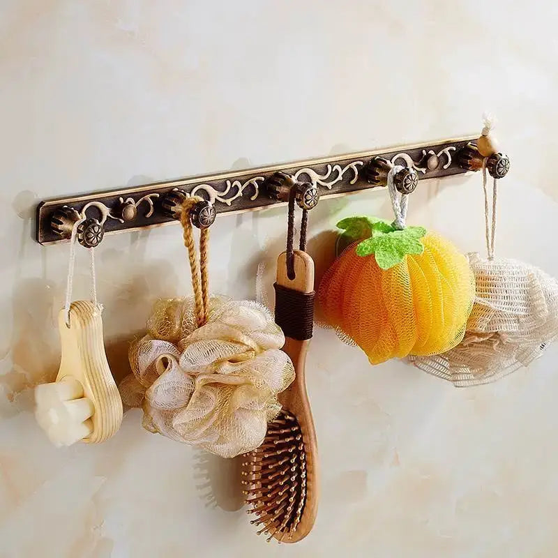 Antique brass floral bath hardware set with towel rack and toilet brush