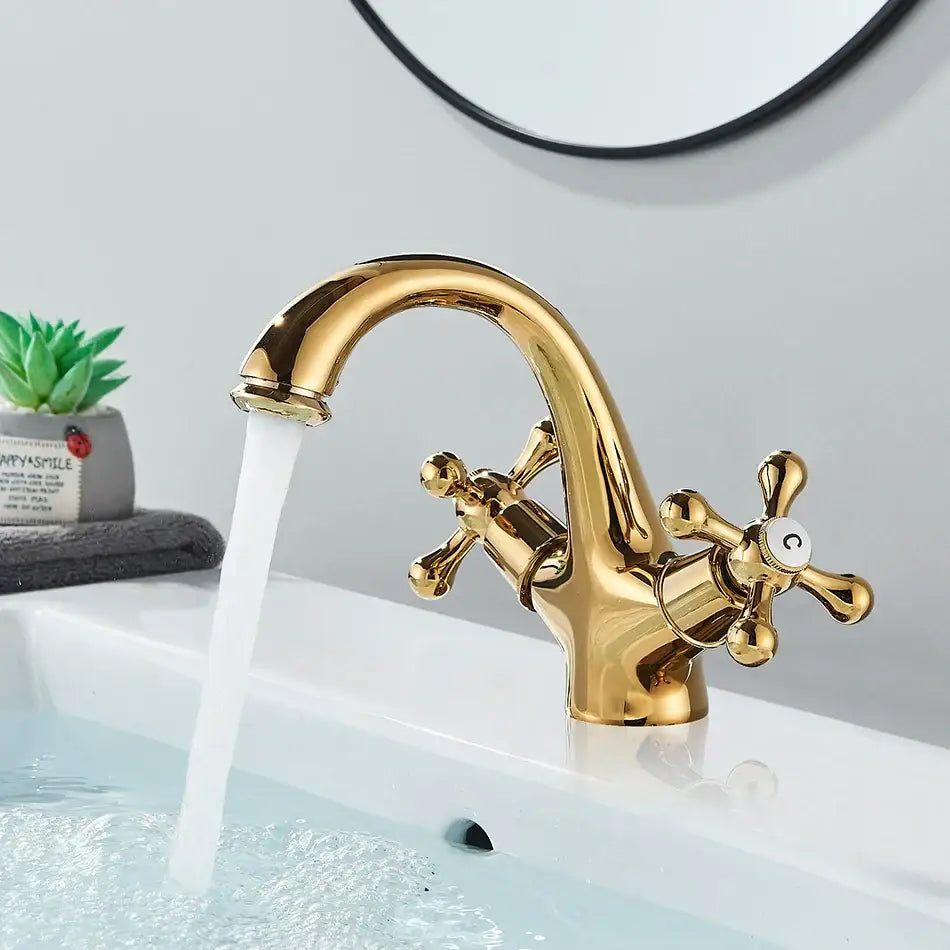 Antique brass basin faucet with ornate cross handles for bathroom