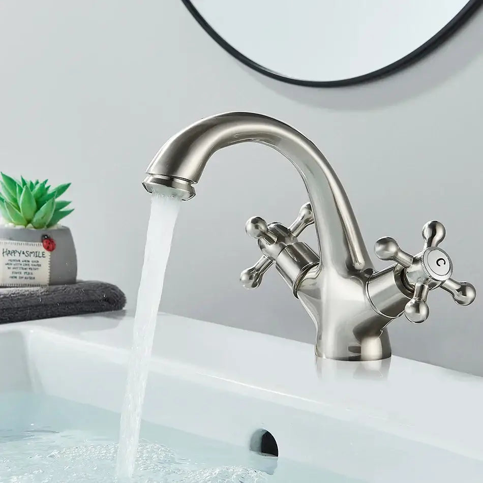 Antique brass basin faucet with ornate cross handles for bathroom