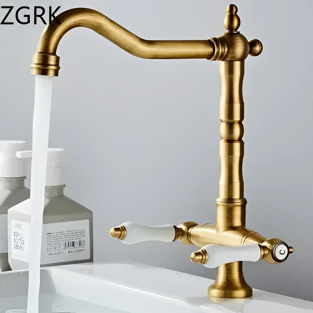 Antique brass kitchen faucet with ceramic handles and curved spout