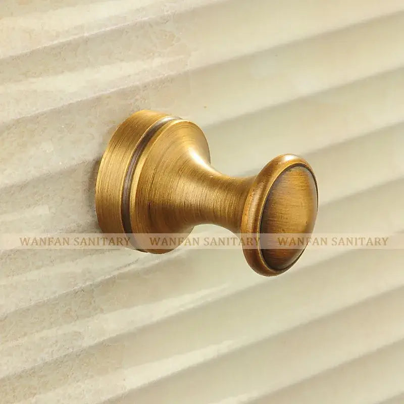 Antique brass robe hook with floral engraving and rope bathroom hook