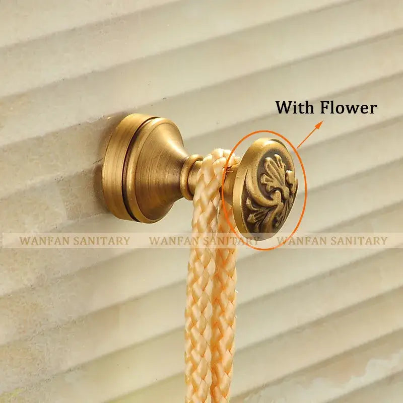 Antique brass robe hook with floral engraving and rope bathroom hook