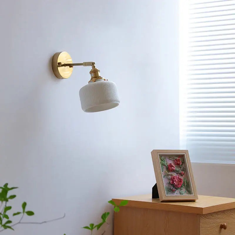 Ribbed white glass and brass ceramic wall sconce for bedroom lighting