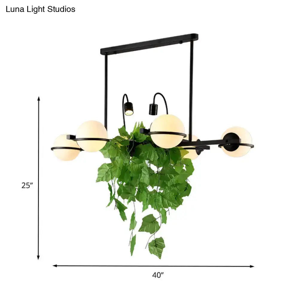 Vintage black and white island lighting fixture with plant for kitchen