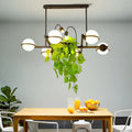 Vintage black and white island lighting fixture with plant for kitchen
