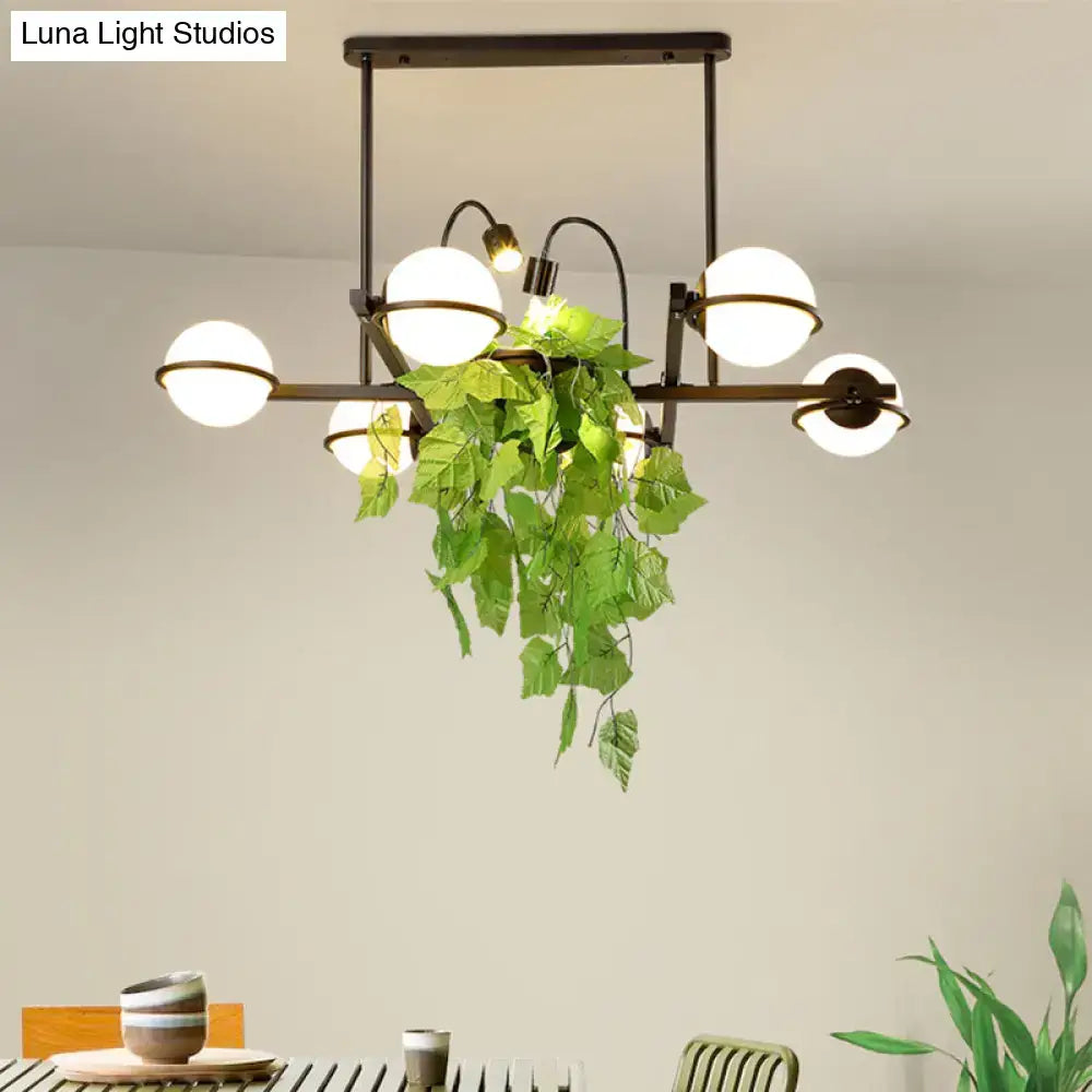 Vintage black and white island lighting fixture with plant for kitchen