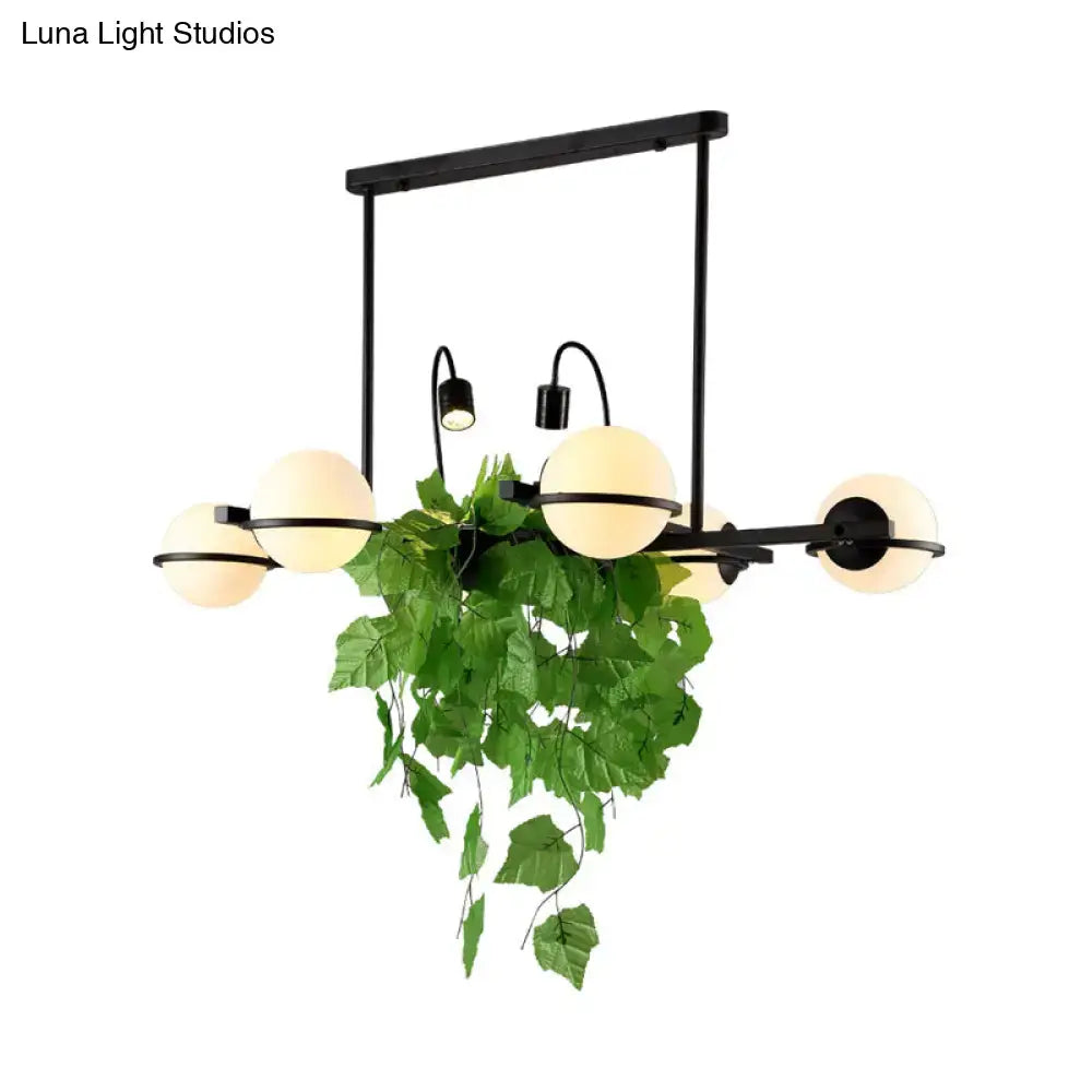 Vintage black and white island lighting fixture with plant for kitchen