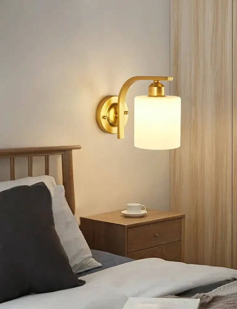 Elegant gold iron wall lamp with frosted glass shade for bedroom
