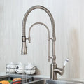 Golden kitchen faucet with white ceramic handle and swivel spout