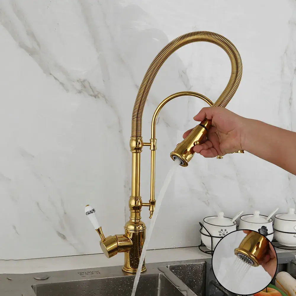 Golden kitchen faucet with white ceramic handle and swivel spout