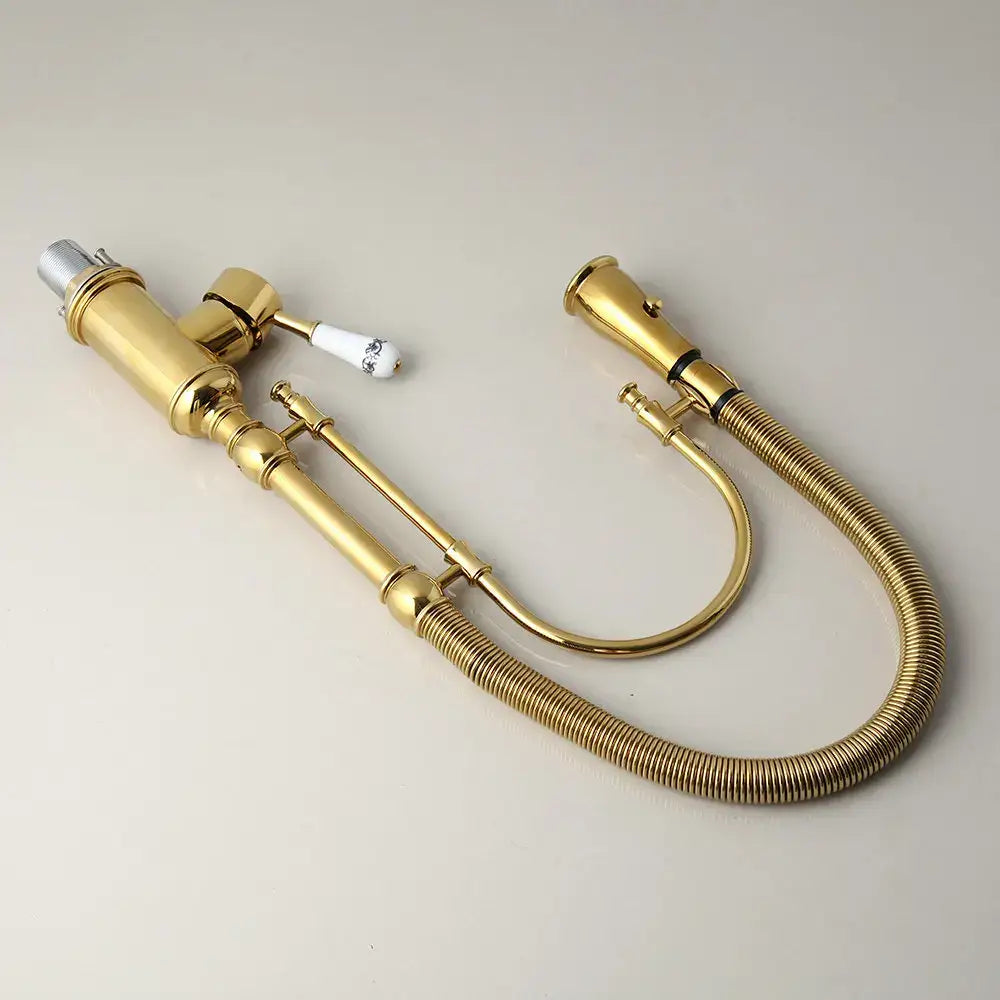 Golden kitchen faucet with white ceramic handle and swivel spout