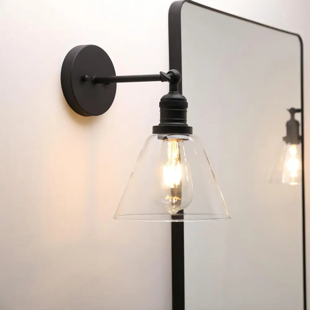 Industrial black wrought iron wall lamp with clear glass shade bedroom