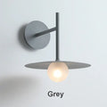 Minimalist black flying saucer wall lamp for bedroom decor