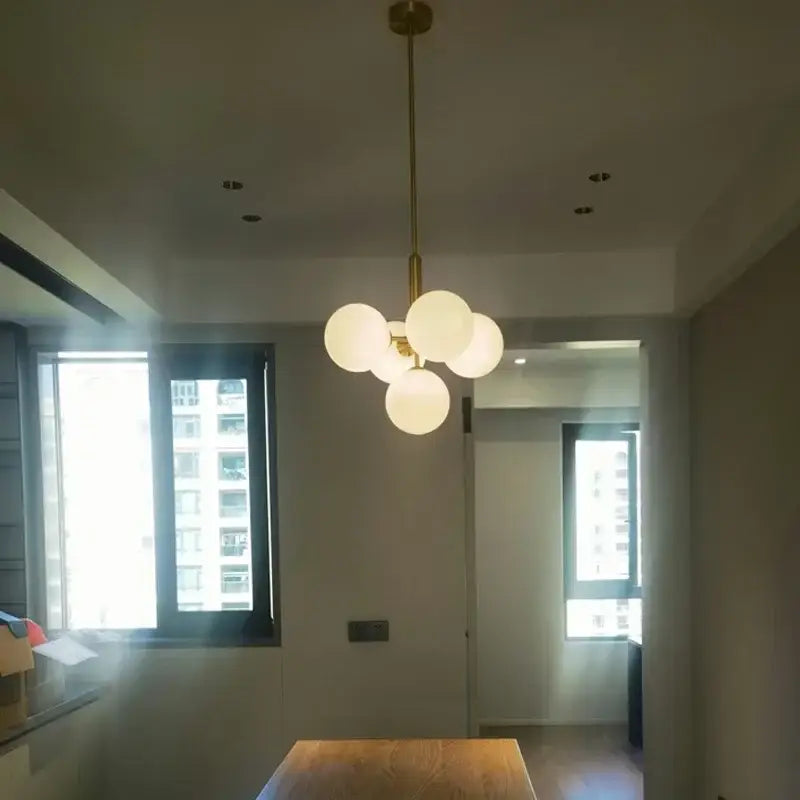 Modern brass and frosted glass chandelier for living room dining decor