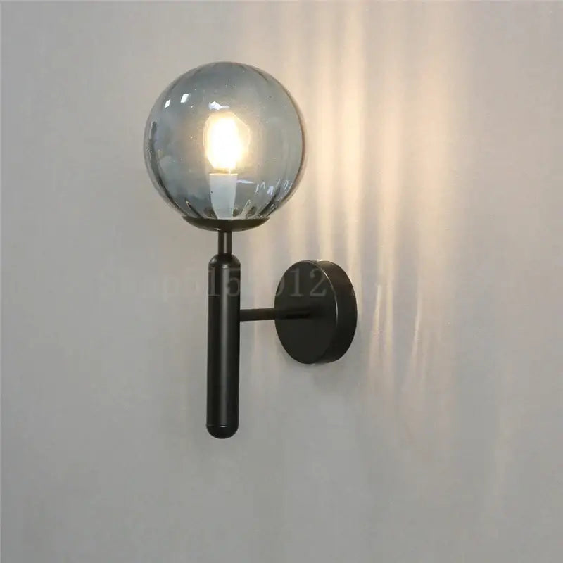 Modern brass and pink glass wall sconce for bedroom