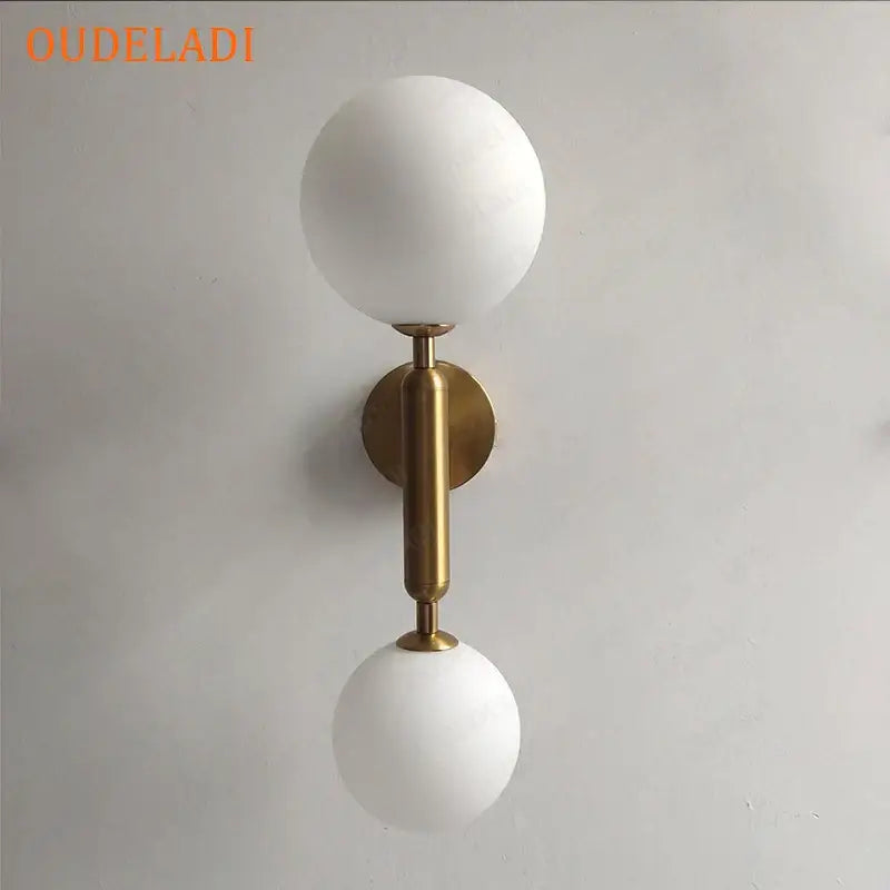 Modern golden led wall sconce with milky glass globes for bedroom