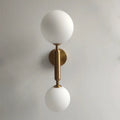 Modern golden led wall sconce with milky glass globes for bedroom