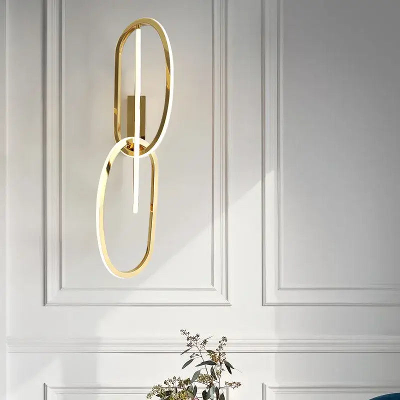 Modern interlocking oval gold wall sconce lighting fixture bedroom