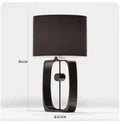 Modern matte black metal table lamp with fabric shade for living room