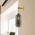 Post-modern brass and smoke gray glass cylinder sconce – bedroom light