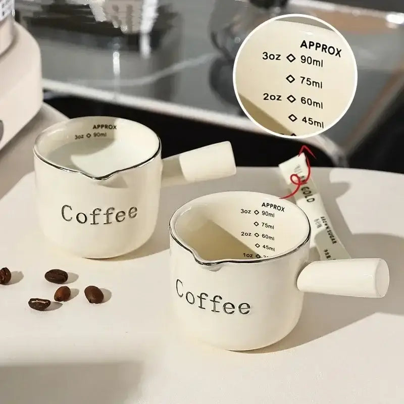 White ceramic espresso measuring cup and milk pitcher kitchen decor